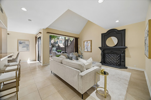 Buy this luxury house in Houston (United States) - bright living room with fireplace and sofa