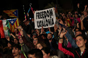 People react as they gather at Plaza Catalunya after voting ended for the banned independence referendum, in Barcelona, Spain October 1, 2017.