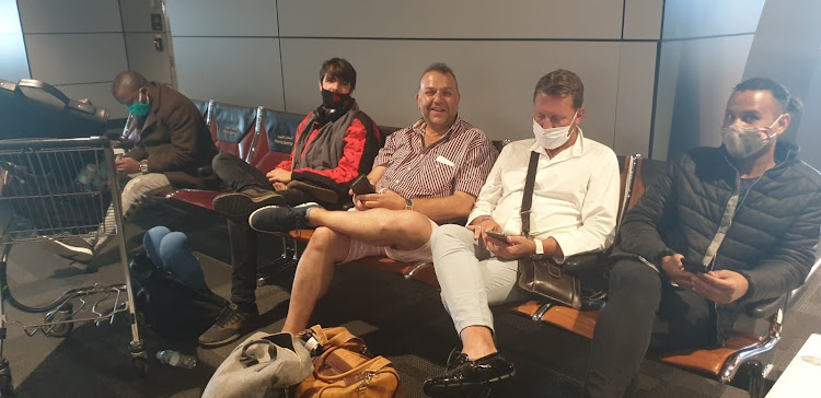 Bay paramedic Clifford Hanks (not pictured) and, from left, Zwelinjani Meyiwa, Benjamin Sturgeon, Athanasios Varonou, Jan Beetge and Banjamin Sturgeon are trapped in the Doha International Airport