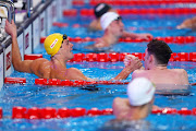 Isaac Cooper congratulates runner-up Hunter Armstrong after winning the men's 50m backstroke title in Doha on Sunday. 