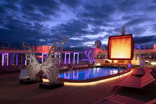  The colorful pool deck of the groundbreaking Celebrity Edge at night. 