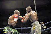 ON TARGET: National junior middleweight champion Tshepo Mashego, left, exchanges blows with Karama Nyilawila at Nasrec Arena last Friday. Pic: Tsheko Kabasia. 21/08/2009. © Sowetan.
21/08/2009 : S A Junior Middle Weigth Champion Tshepo Mashego of Witbank in action against Karama Nyilawila of Tanzania. Tshepo won on points after ten rounds in Nasrec Sports Centre.