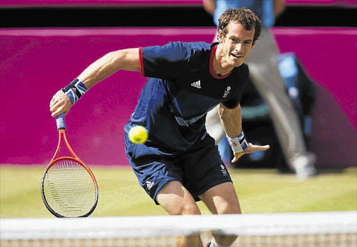 Britain's Andy Murray on his way to thrashing Switzerland's Roger Federer in the men's singles gold medal match on the grass courts of Wimbledon yesterday Picture: DOMINIC EBENBICHLER/REUTERS