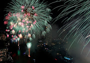 Fireworks explode over the Chao Phraya River during the 2022 New Year celebrations in Bangkok, Thailand.