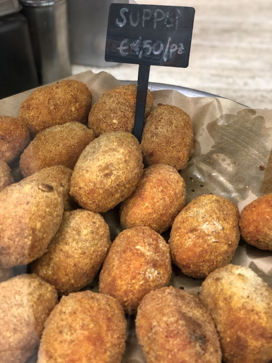 I liked these! Served warm. Breaded rice balls with tomato sauce and mozzarella oozing out when you cut into it.