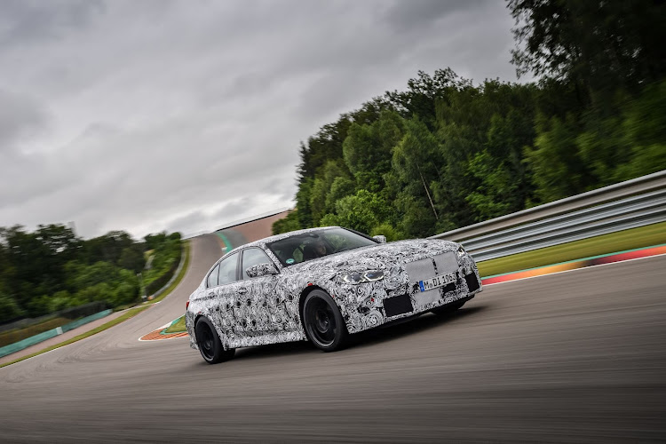 A new and heavily camouflaged BMW M3 Sedan in action around the Sachsenring.