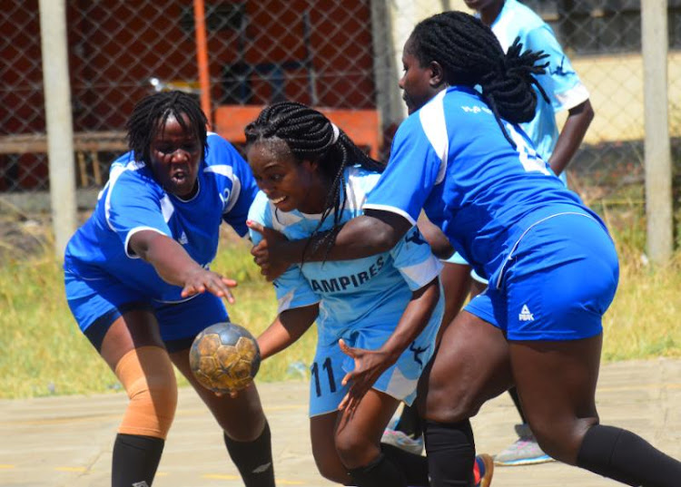 Nairobi Queens' Elizabeth Kemei (L ) and Brenda Musambai fight for the ball with Irene Aloo of Kenyatta University during a past national league match at Kaloleni grounds