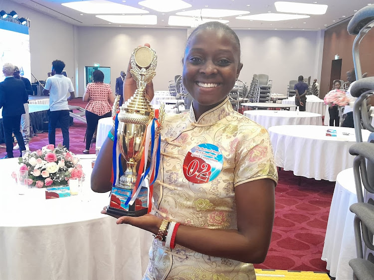Jeanne Ong'iyo from Moja Express Way holding her trophy during the Belt and Road: My China Story Speech Competition Final which was held at the Radisson Blu hotel in Nairobi on October 13, 2023.