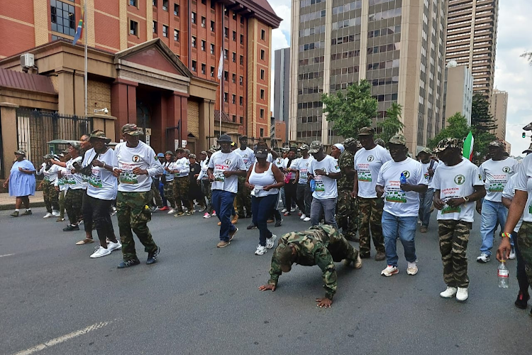 Operation Dudula members march outside the Pretoria High court on Monday.