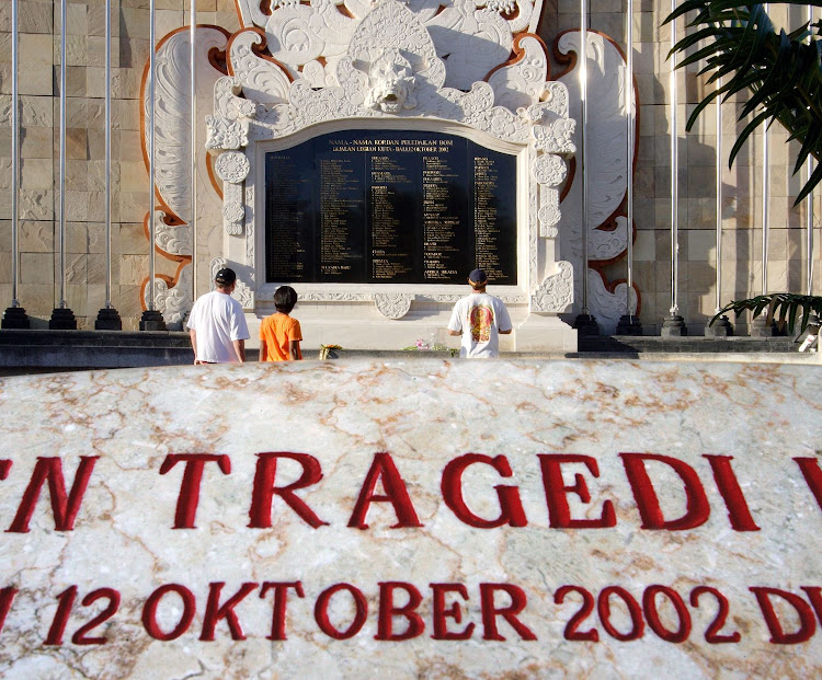 Tourists visit the Bali bombing memorial on Sunday, February 6, 2005, at the site in Kuta where the 2002 blasts killed more than 200 people. Photo: Jonathan Drake/Bloomberg News