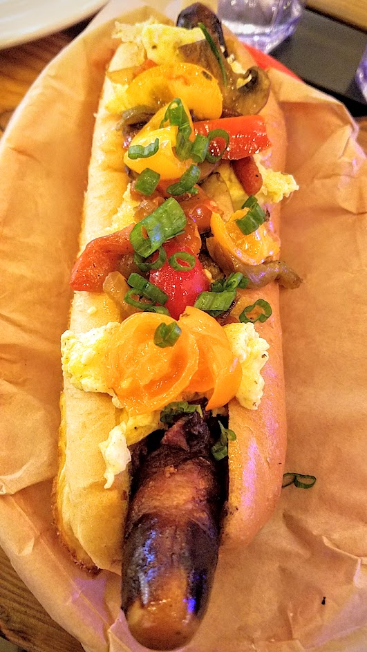 Brunch at Pine Street Market includes OP Wurst with their four breakfast hot dogs, such as this Breakfast Dog with Bacon-wrapped frankfurter, seasonal scramble, cheddar cheese