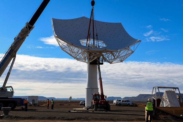 A composite image of the future SKA-Mid telescope, blending the existing precursor MeerKAT telescope dishes already on site with an artist's impression of the future SKA-Mid dishes.