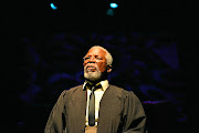 John Kani plays advocate Xola Mlambo who builds a damning case against King Leopold II for his crimes in the Congo.