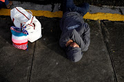 People sleep before departing with a caravan of migrants from El Salvador en route to the United States, in San Salvador, El Salvador, October 28, 2018. 