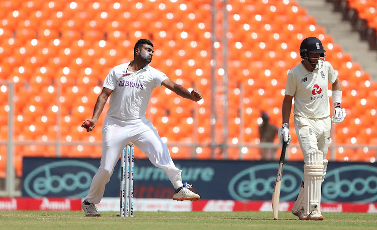 Ravichandran Ashwin of India bowls while Joe Root of England backs up during at the Narendra Modi Stadium on March 6, 2021 in Ahmedabad