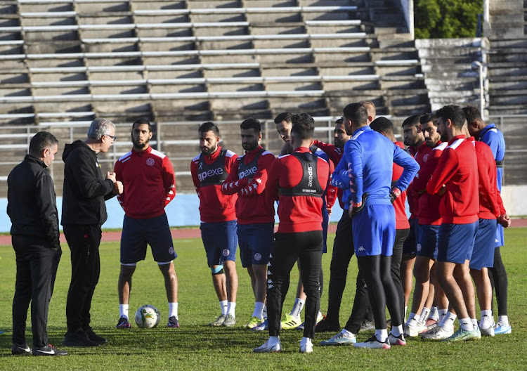 Tunisia's national football team coach Mondher Kbaier (2nd L) speaks to his players during a training session at the el-Menzah stadium in Tunis on December 29, 2021