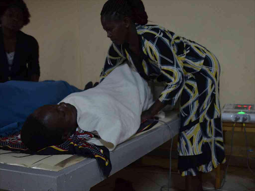 Immaculate Khaemba undergoes a theotherapy exercise to strengthen her muscles at a facility in Kitale town, February 12, 2018. /CRAZON WAFULA