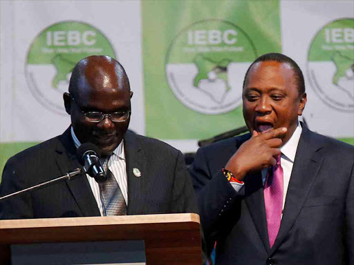 IEBC chairman Wafula Chebukati and President Uhuru Kenyatta at the IEBC National Tallying Centre at the Bomas of Kenya, Nairobi, on Friday, when Uhuru was announced winner of the presidential election /REUTERS /THOMAS MUKOYA