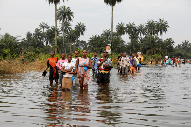 Residents wade through flood water in Obagi community, Rivers state, Nigeria, on October 21 2022. Picture: REUTERS/TEMILADE ADELAJA