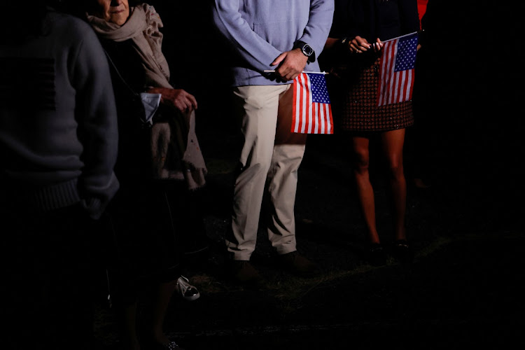 Family members with US flags wait to greet freed American detainees released in a prisoner swap deal between US and Iran upon arriving at Davison Army Airfield at Fort Belvoir, Virginia, US, on September 19 2023. Picture: JONATHAN ERNST/REUTERS