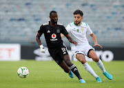 Deon Hotto of Orlando Pirates is challenged by Oussama Bellatrache of JS Saoura in the Caf Confederation Cup Group B match at Orlando Stadium in Soweto on the February 13 2022.