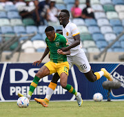 Kaizer Chiefs striker Caleb Bimenyimana challenges Pule MModi of Golden Arrows during their DStv Premiership at Moses Mabhida Stadium.
