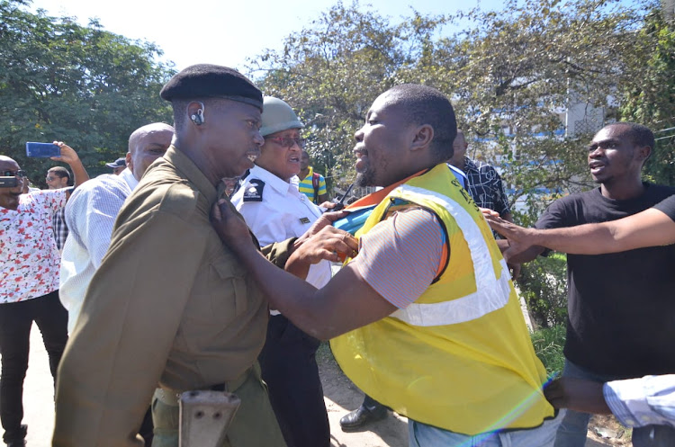 A protester squares up with a police officer near the Nyali bridge on Monday, October 7, 2019.