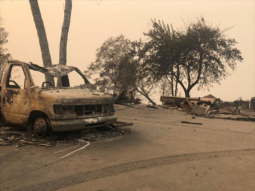 The wreckage of a vehicle is seen along the road in the aftermath of wildfires in Paradise, California, US, November 12, 2018. /REUTERS