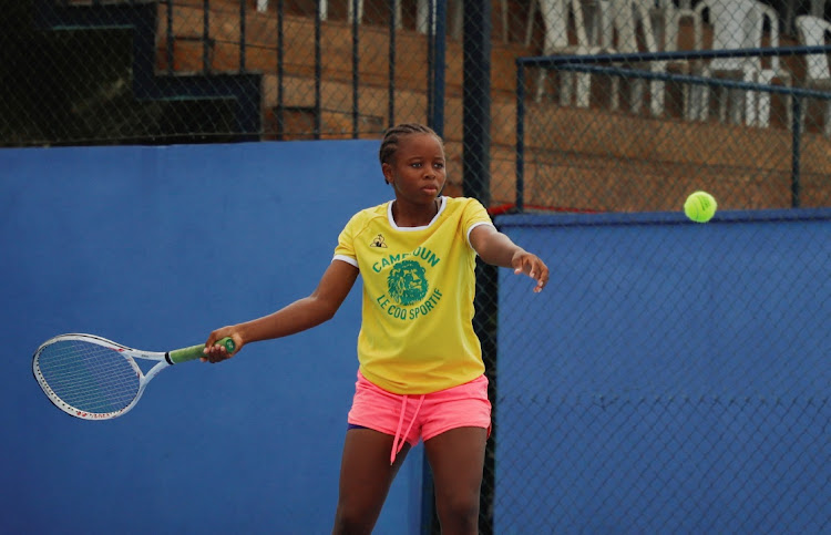 Manantsop Delisle, 14, a young tennis player and intern, trains at Oyebog, a tennis academy for young, disadvantaged players founded by Joseph Oyebog, a former Cameroonian tennis champion, in Souza, Cameroon April 29, 2023.
