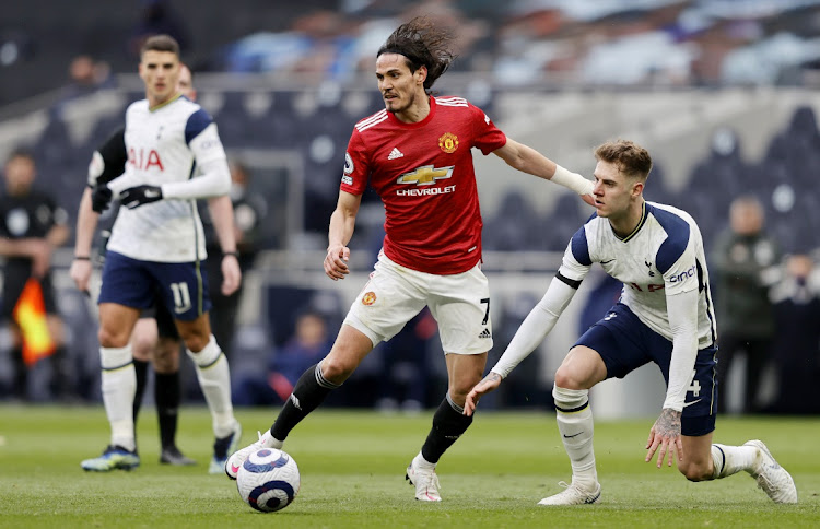 Edinson Cavani of Manchester United battles for possession with Joe Rodon of Tottenham Hotspur during the Premier League match at Tottenham Hotspur Stadium on April 11, 2021 in London