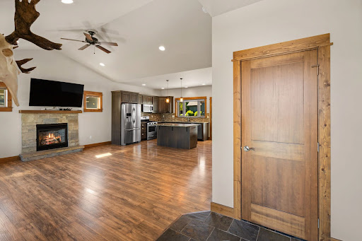 Open living and kitchen area with fireplace - Luxury house for sale in Bozeman, 3 bedrooms