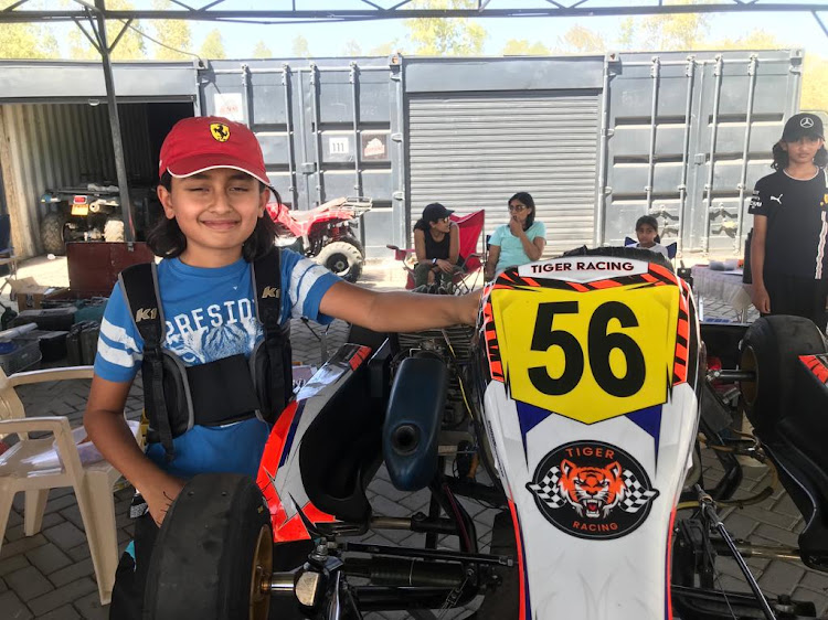 Shane Candaria inspects his kart during the final round of Kenya National Karting Championships at Whistling Moran. He won the race and was crowned 2022Cadet Class champion