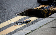 A knife lies on the pavement after being recovered by the police from a drain following reported stabbings in Birmingham, Britain, on September 6 2020. 