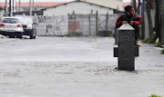 Child playing in a flooded road in Cape Town on Wednesday. 