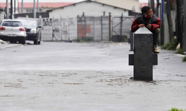 Child playing in a flooded road in Cape Town on Wednesday.