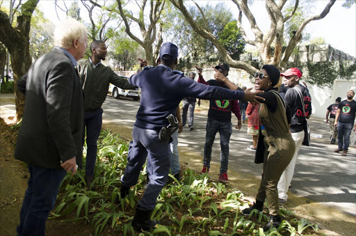 29 June 2017. Members of the socialist organisation Black First Land First threaten editor Business Day newspaper, Tim Cohen, because he tried to take a picture of them. Picture : Lefedi Radebe