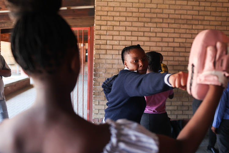 Pupils take part in a self-defence class.