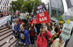 In this May 15, 2017 file photo, protesters wave signs and chant during a demonstration against President Donald Trump’s revised travel ban