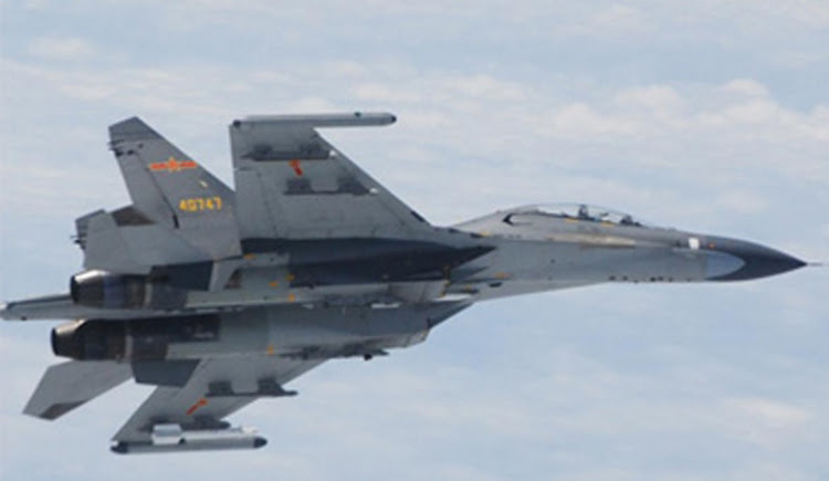 A Chinese SU-27 fighter jet flies over the East China Sea.