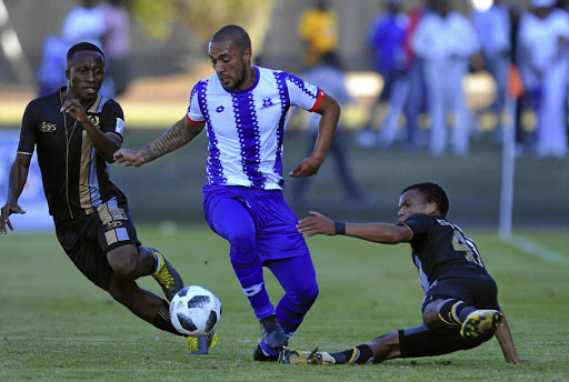 Miguel Timm of Maritzburg United is sandwiched by challenged by Royal Eagles markers as Maritzburg went on to win their first play-offs game 1-0. / Sydney Mahlangu/ BackpagePix