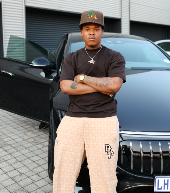 Nasty C posing alongside his Mercedes-AMG CLA 45.