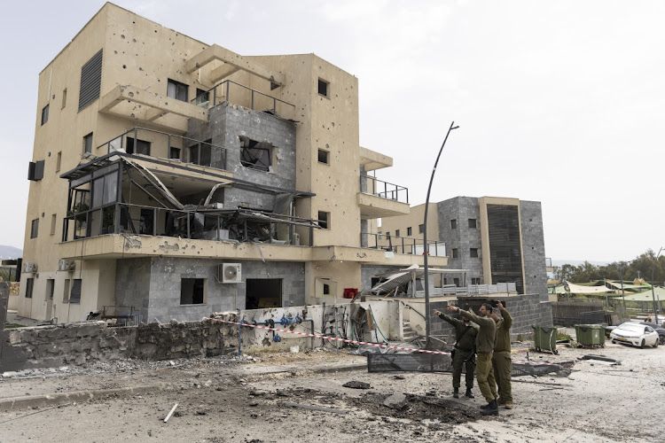 Israeli emergency responders inspect a building that was damaged from a rocket fired from Lebanon on March 27, 2024 in Kiryat Shmona, Israel. One man was killed after the Hezbollah rocket barrage on the Northern Israeli city. Picture: AMIR LEVY