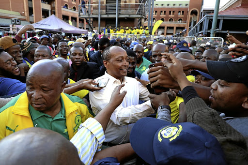 Hlompho Kekana and Sibusiso Vilakazi lead Sundowns players in celebration during the parade.