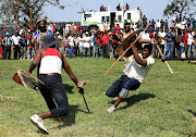 Police look  on as the regiments fight.