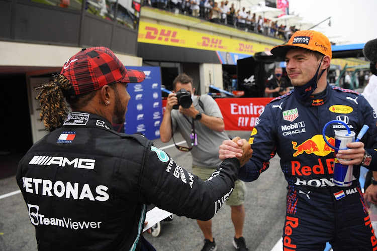 Pole position qualifier Max Verstappen of Netherlands and Red Bull Racing and second-placed qualifier Lewis Hamilton of Great Britain and Mercedes GP interact in parc ferme during qualifying ahead of the F1 Grand Prix of France at Circuit Paul Ricard in Le Castellet on June 19, 2021.