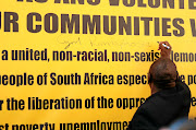 President Cyril Ramaphosa puts his signature on a banner outside Luthuli House yesterday before  unveiling the Thuma Mina Campaign, which will eventually be rolled out around the country.