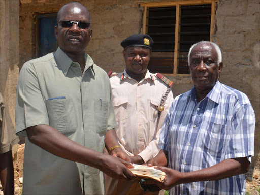 Coast Regional Coordinator John Elungata, Kilifi county commissioner Magu Mutindika and James Keah at the latter's home in Kaloleni / ERNEST CORNEL