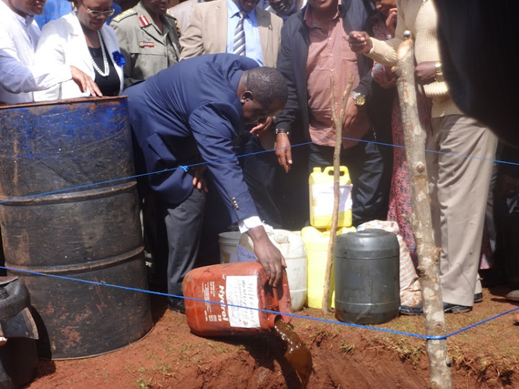 Interior CS Fred Matiang'i and other government officials destroy illicit liquo in Makwa village, Gatundu North in March 2018.