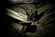 A young boy fetches coal from a defunct mine in Ermelo, Mpumalanga, in an operation run by illegal miners.