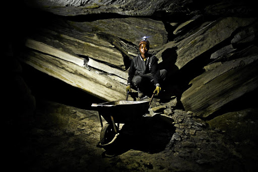 A young boy fetches coal from a defunct mine in Ermelo, Mpumalanga, in an operation run by illegal miners.